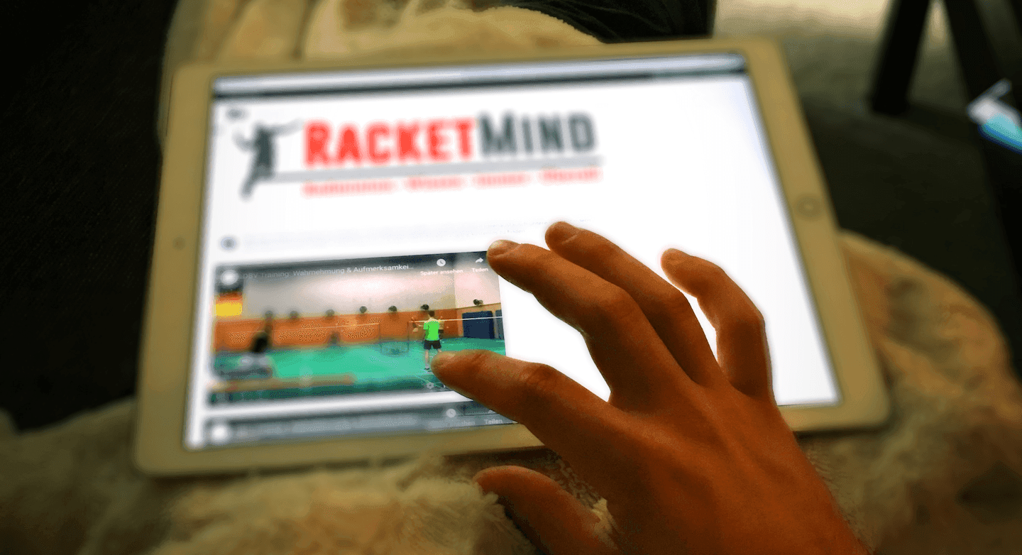 A person watching a video at RacketMind online learning platform on a tablet